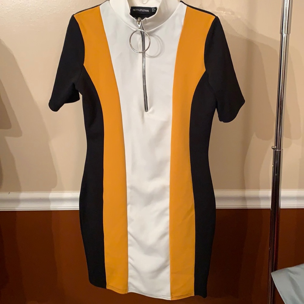 Brand new, never worn, no tag.  Polyester dress with silver circle zipper.